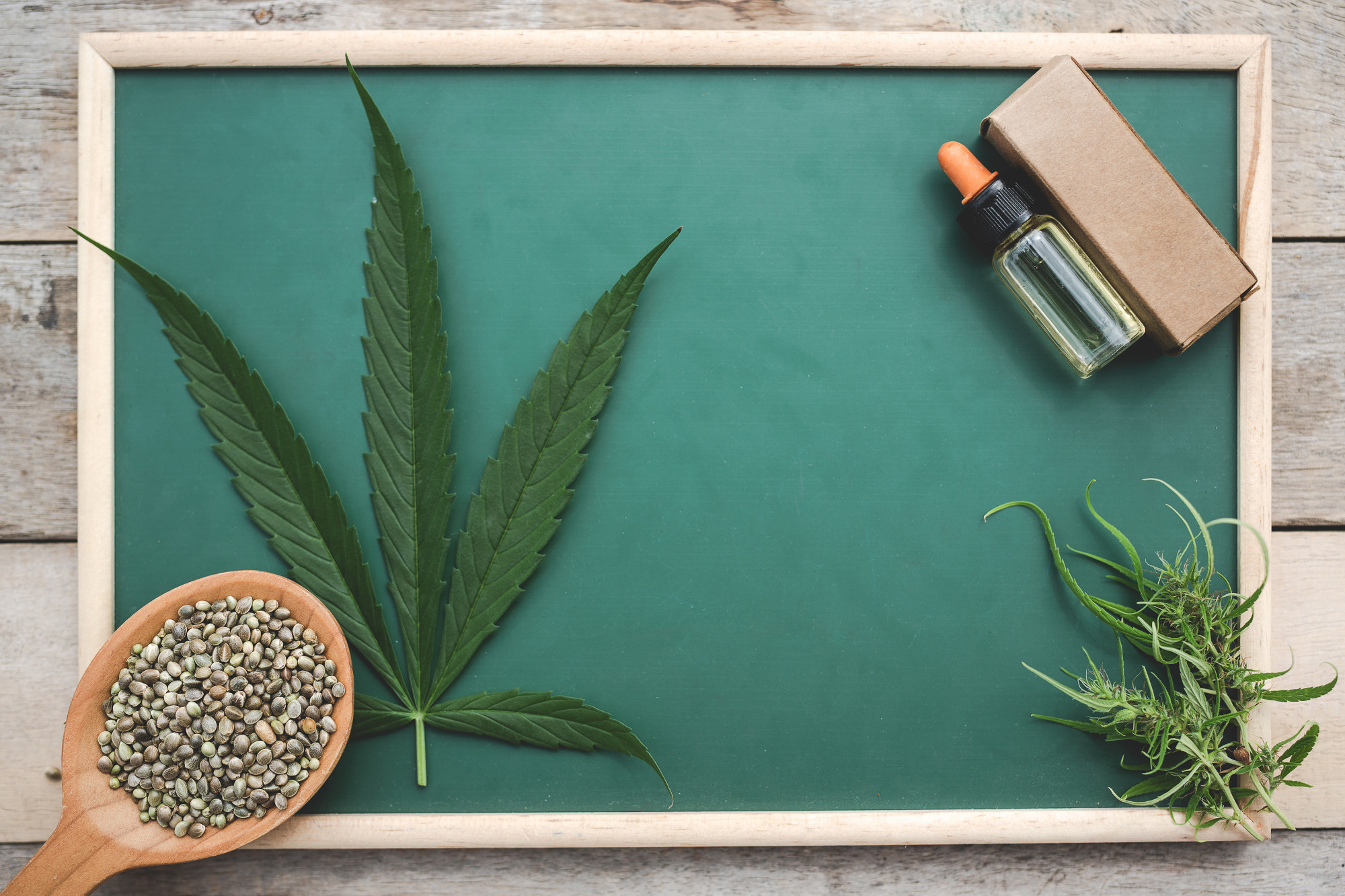 cannabis-cannabis-seeds-cannabis-leaves-cannabis-oil-placed-green-board-wooden-floor